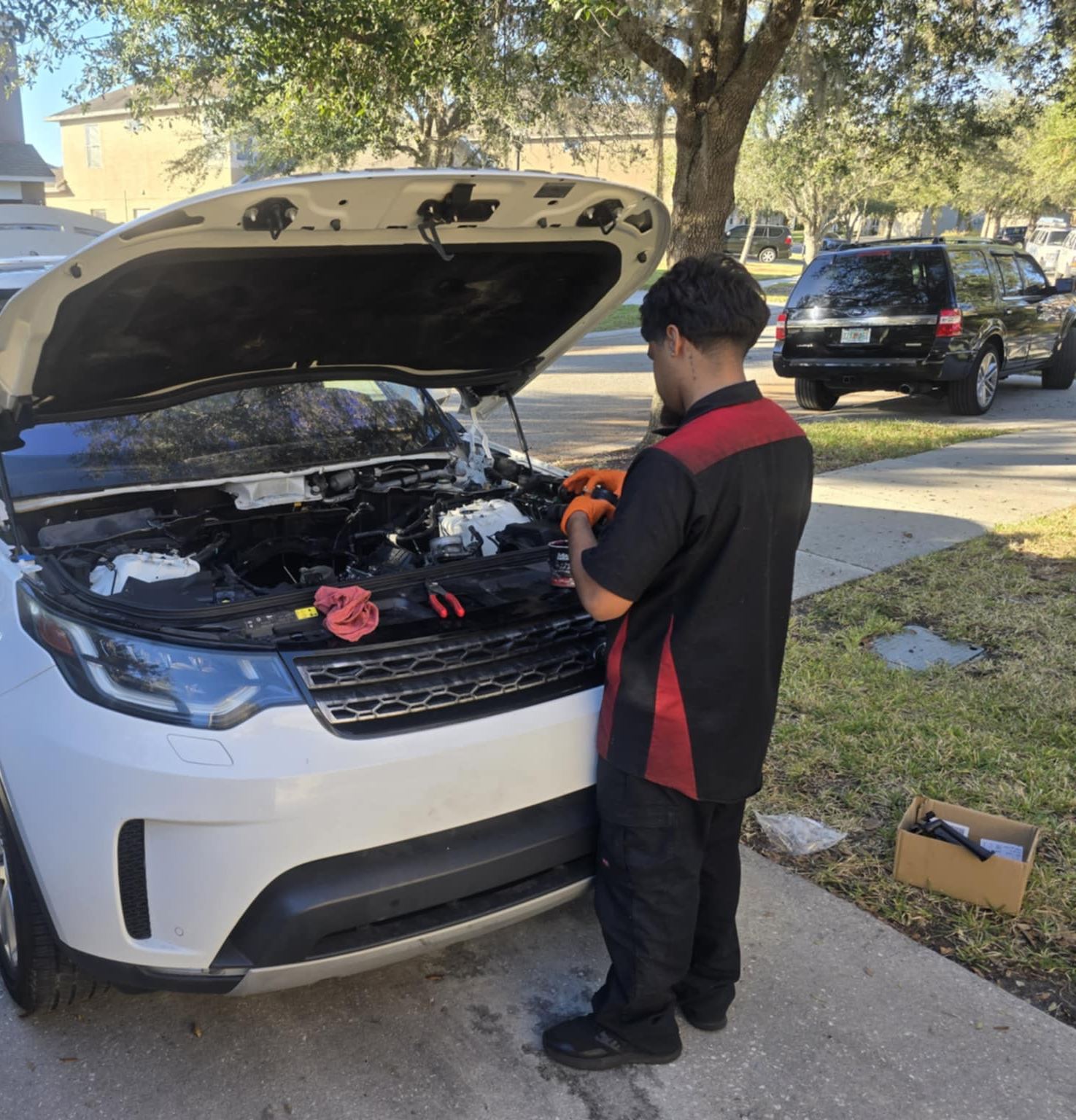 Orlando's Finest mobile mechanic servicing an SUV in a customer's driveway in Orlando, FL