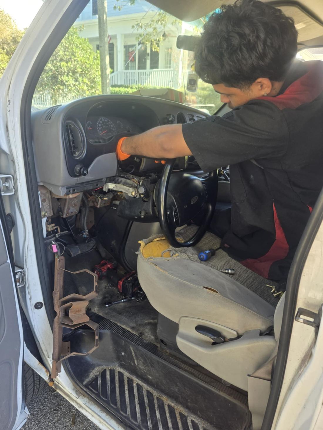 Mobile mechanic repairing a steering column at the customer's location in Orlando